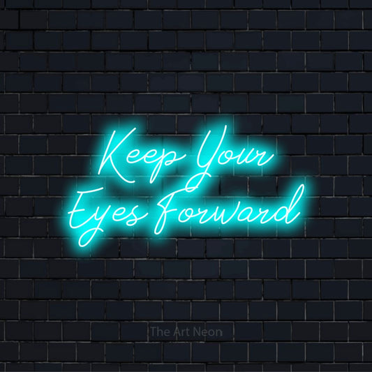 "Keep Your Eyes Forward" neon text design on a black brick wall