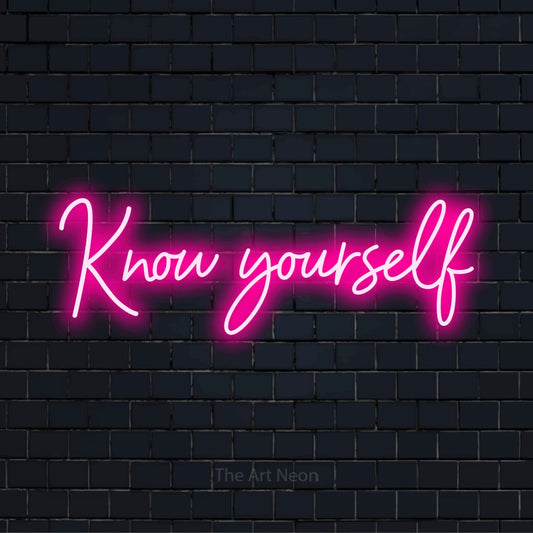 "Know Yourself" glowing LED neon sign on a black brick wall