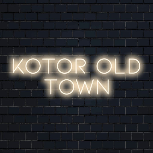 Kotor Old Town Neon Sign, glowing wall decor on dark brick background