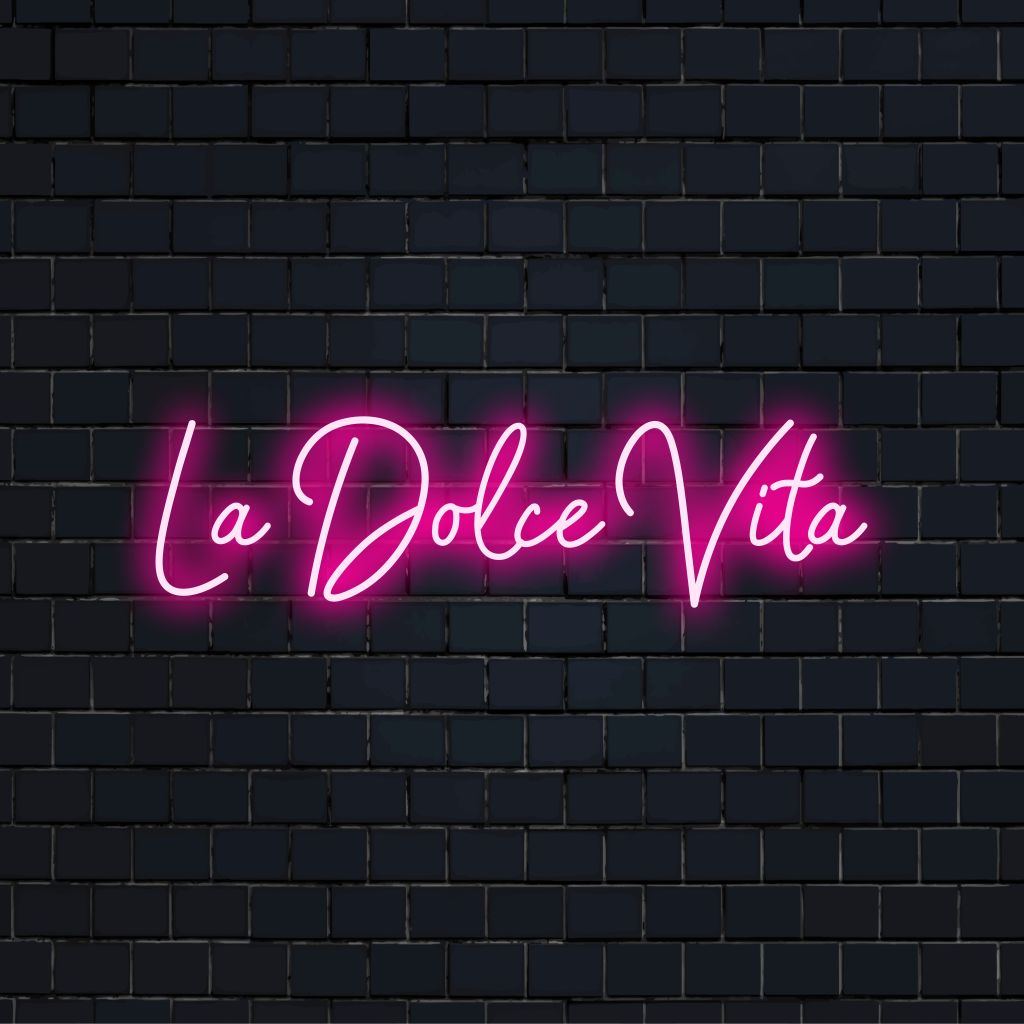 La Dolce Vita Neon Sign, neon text light against brick backdrop