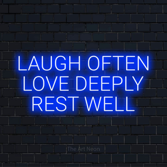 "Laugh Often Love Deeply Rest Well" glowing LED neon sign on a black brick wall