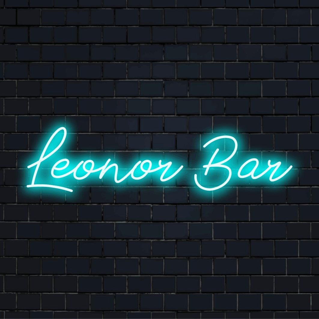 Leonor Bar Custom Name Neon Sign, neon text light against black brick wall
