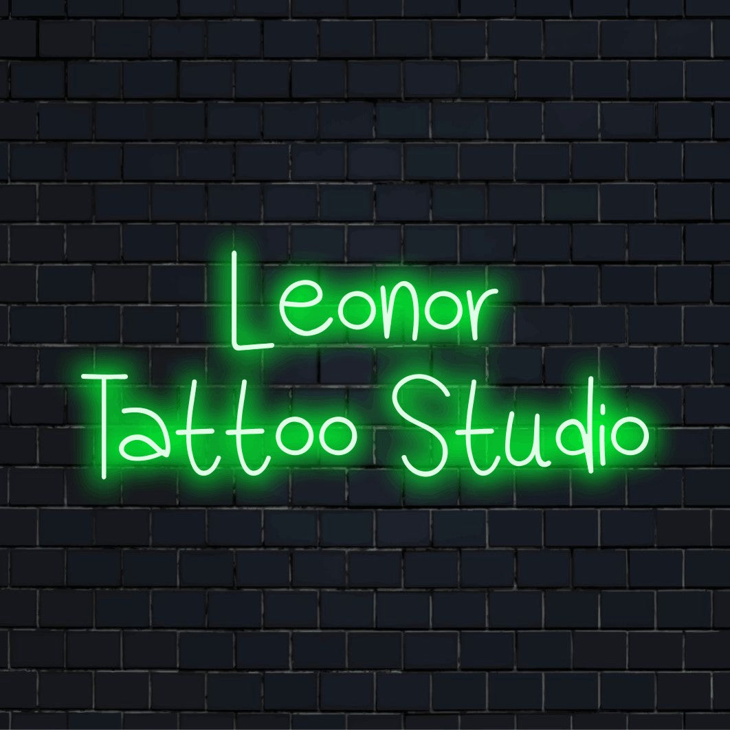 Leonor Tattoo Studio Custom Name Neon Sign, soft neon glow on black brick background