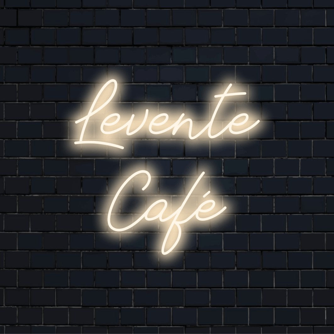 Levente Cafe Personalized LED Neon Sign, glowing neon text against black brick wall