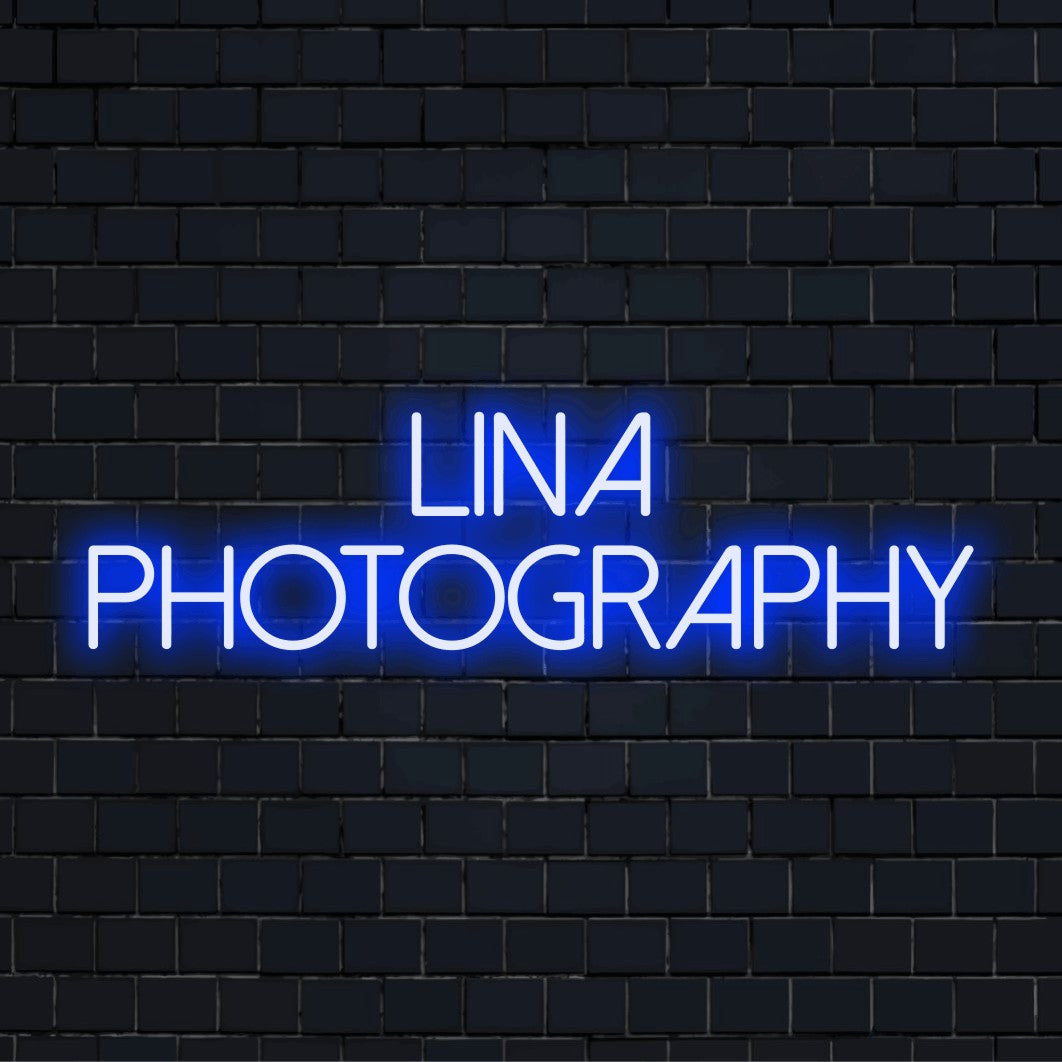 Lina Photography Custom Name Neon Sign, bright neon glow against black brick wall