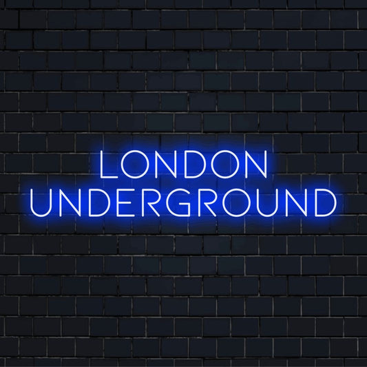 London Underground Neon Sign, bright neon lettering on dark brick wall