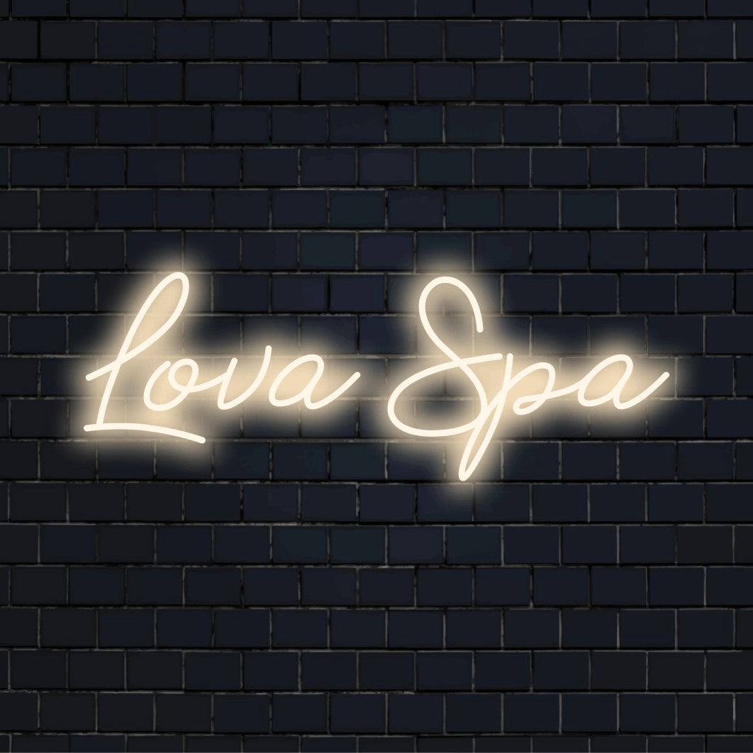 Lova Spa Custom Name Neon Sign, bright neon lettering on dark brick wall