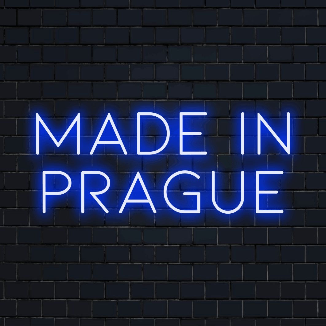 Made In Prague Neon Light with bright neon lettering on dark brick background