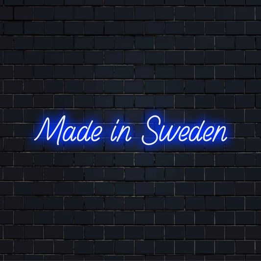 Made In Sweden Neon Light with bright neon lettering on dark brick wall