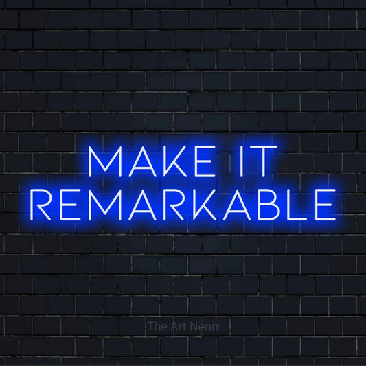 "Make It Remarkable" LED neon sign on a black brick wall