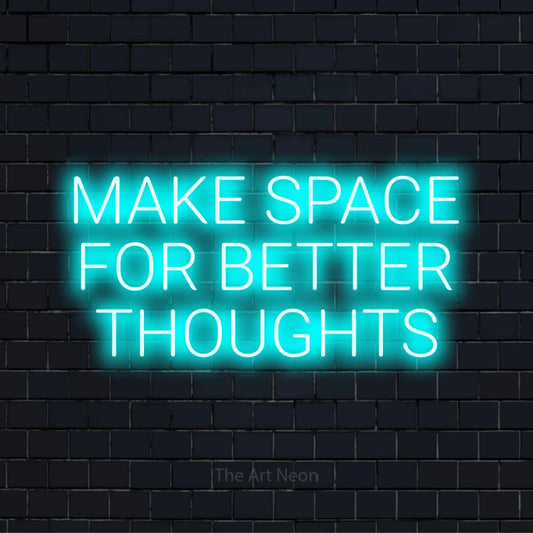 "Make Space For Better Thoughts" LED neon sign on a black brick wall