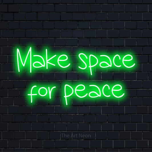 "Make Space For Peace" LED neon sign on a black brick wall