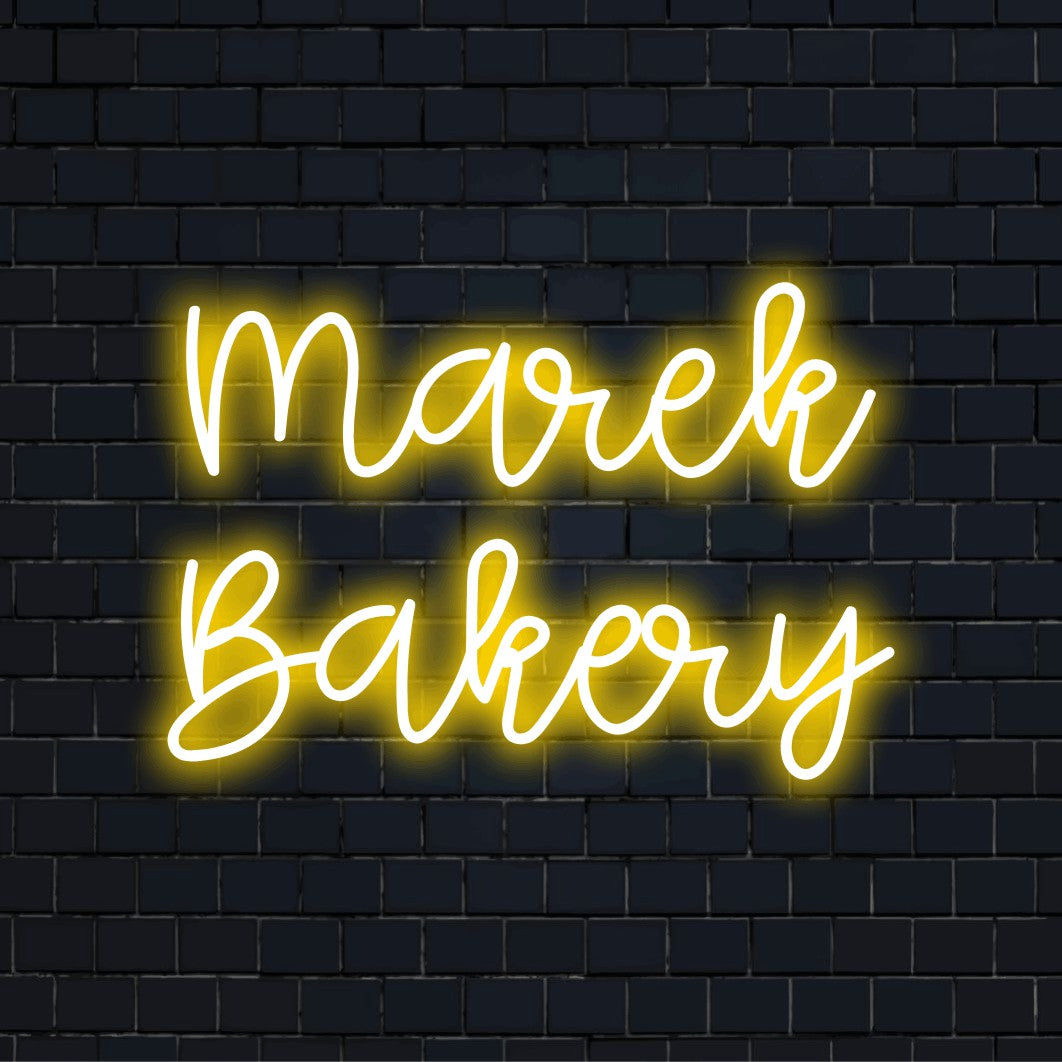 Marek Bakery Personalized LED Neon Sign, glowing lettering on black brick background