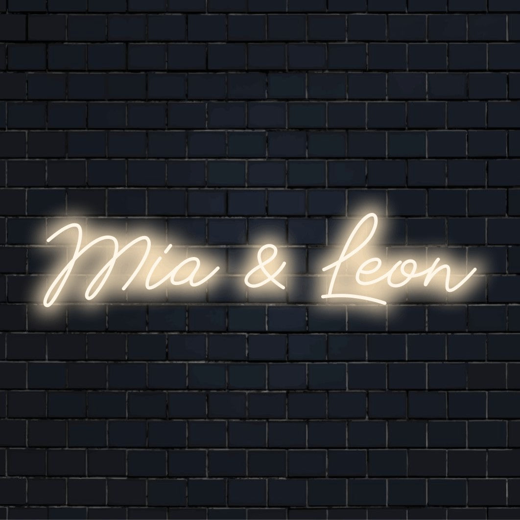 Mia _ Leon Custom Name Neon Sign, glowing lettering against brick backdrop