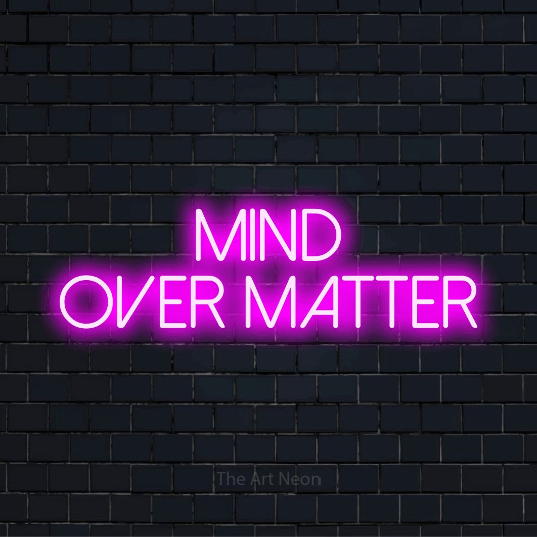 "Mind Over Matter" glowing LED neon sign on a black brick wall
