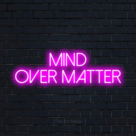 "Mind Over Matter" glowing LED neon sign on a black brick wall