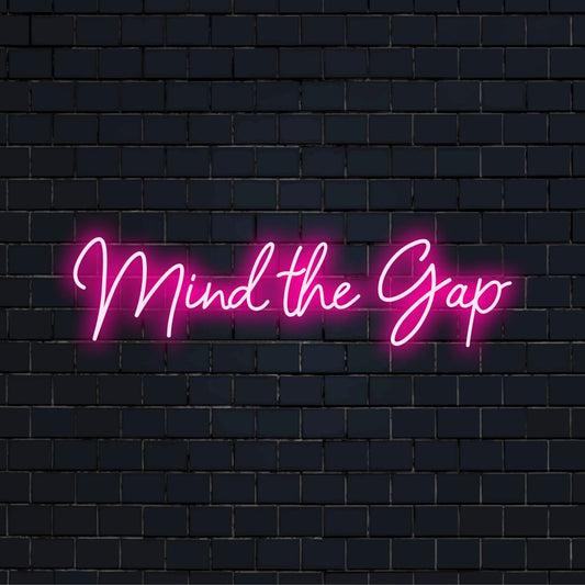 Mind The Gap Neon Sign, neon text light on dark brick wall