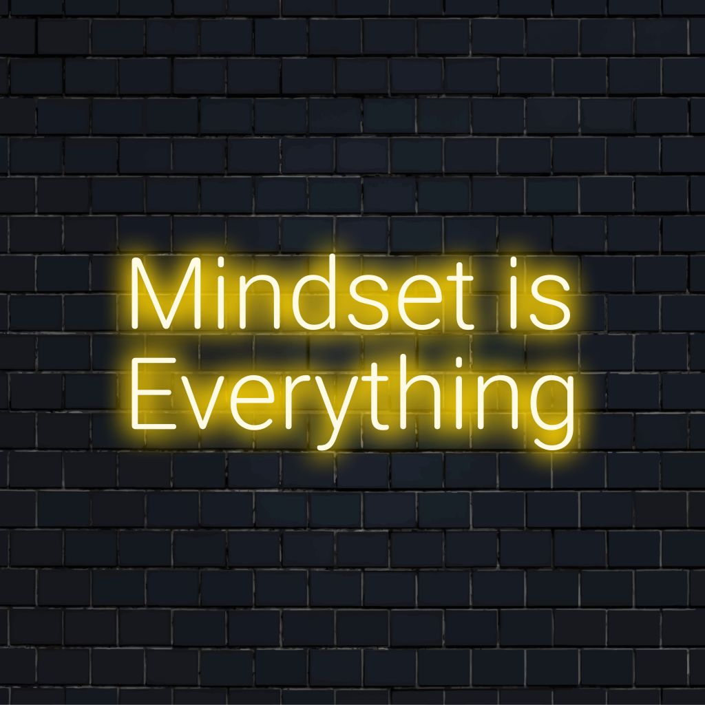 Mindset Is Everything Neon Sign, soft neon glow on dark brick wall