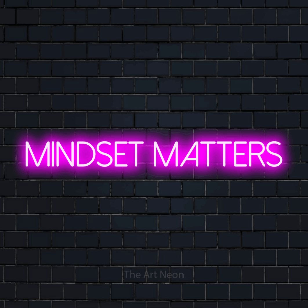 "Mindset Matters" script-style LED neon sign on a black brick wall