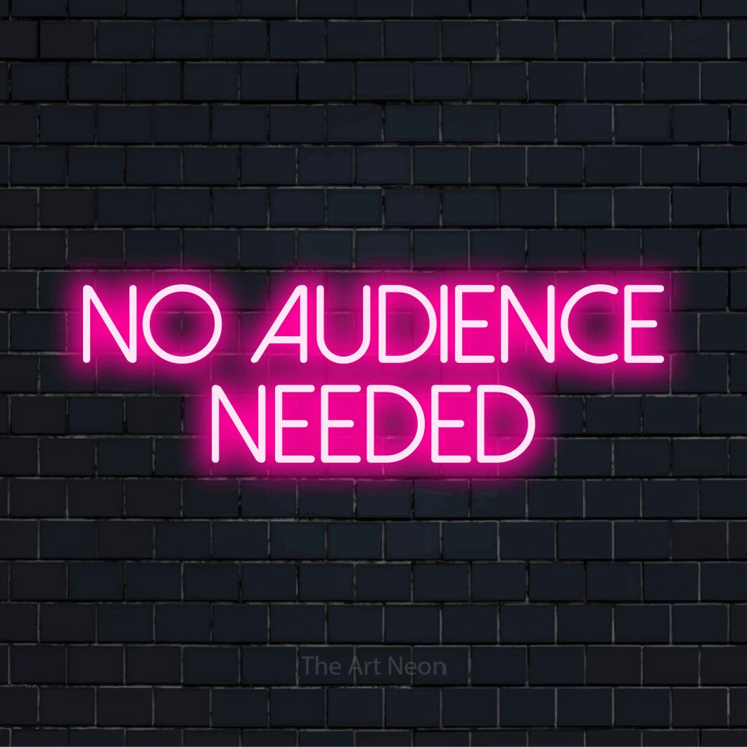 "No Audience Needed" script-style LED neon sign on a black brick wall