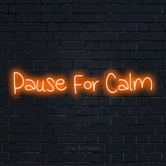 "Pause For Calm" neon text design on a black brick wall
