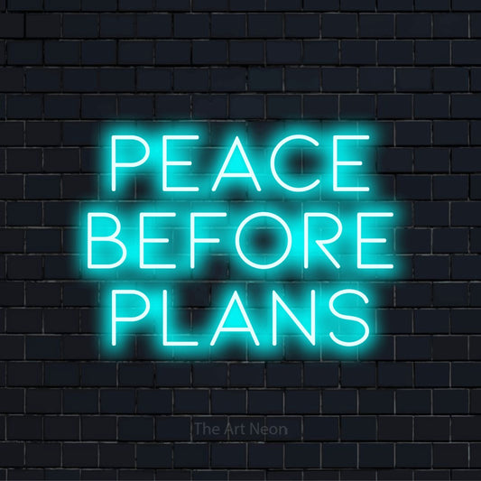 "Peace Before Plans" glowing LED neon sign on a black brick wall