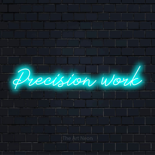 "Precision Work" script-style LED neon sign on a black brick wall