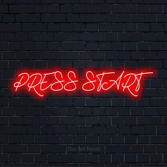 "Press Start" glowing LED neon sign on a black brick wall