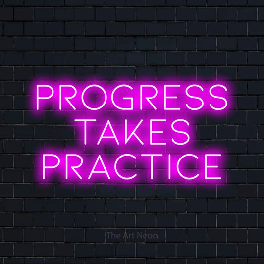 "Progress Takes Practice" script-style LED neon sign on a black brick wall