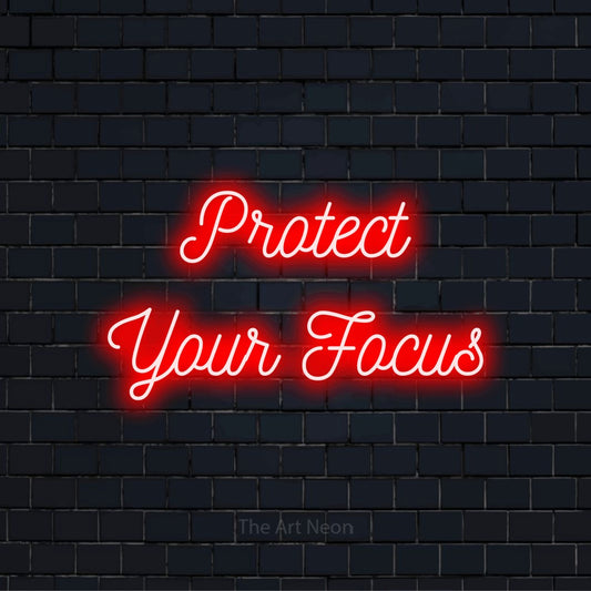 "Protect Your Focus" LED neon sign on a black brick wall