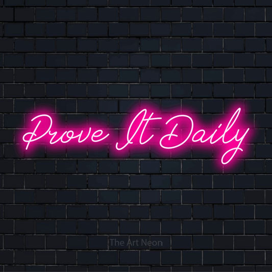 "Prove It Daily" glowing LED neon sign on a black brick wall
