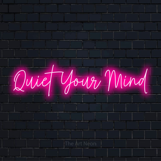 "Quiet Your Mind" neon text design on a black brick wall