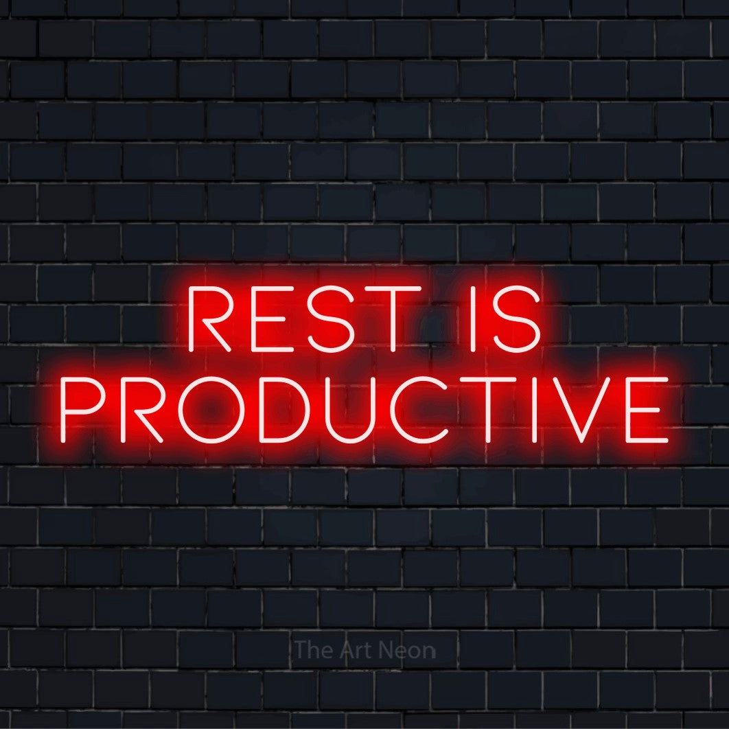 "Rest Is Productive" neon text design on a black brick wall