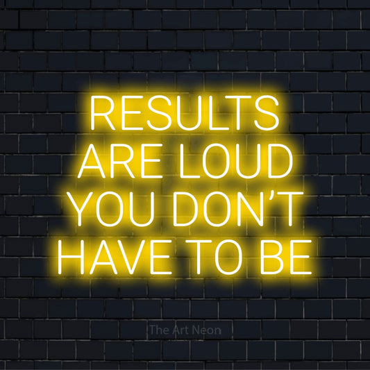 "Results Are Loud You Don’t Have To Be" glowing LED neon sign on a black brick wall