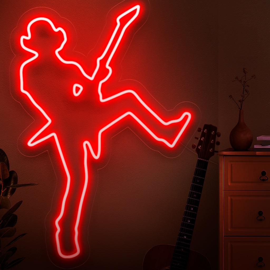 Dynaaminen neonkyltti, jossa on rocktähden siluetti, joka vangitsee elävän musiikin esityksen energiaa ja karismaa.