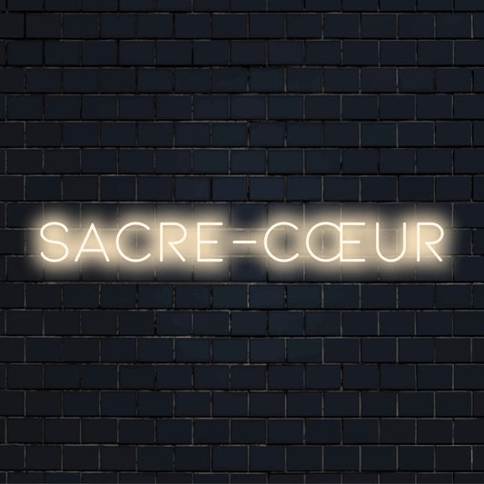 Sacre C Ur LED Neon Sign, bright LED glow on black brick background