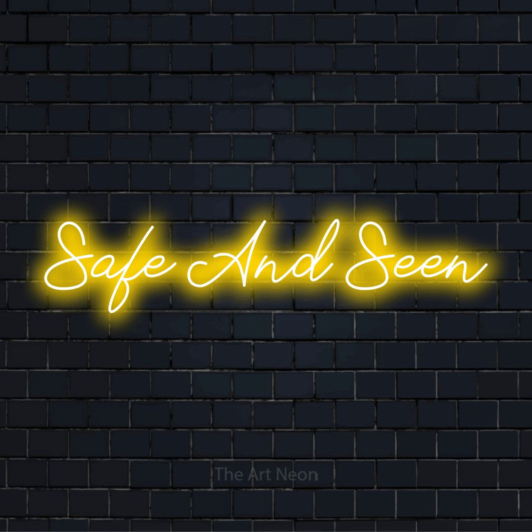 "Safe And Seen" glowing LED neon sign on a black brick wall