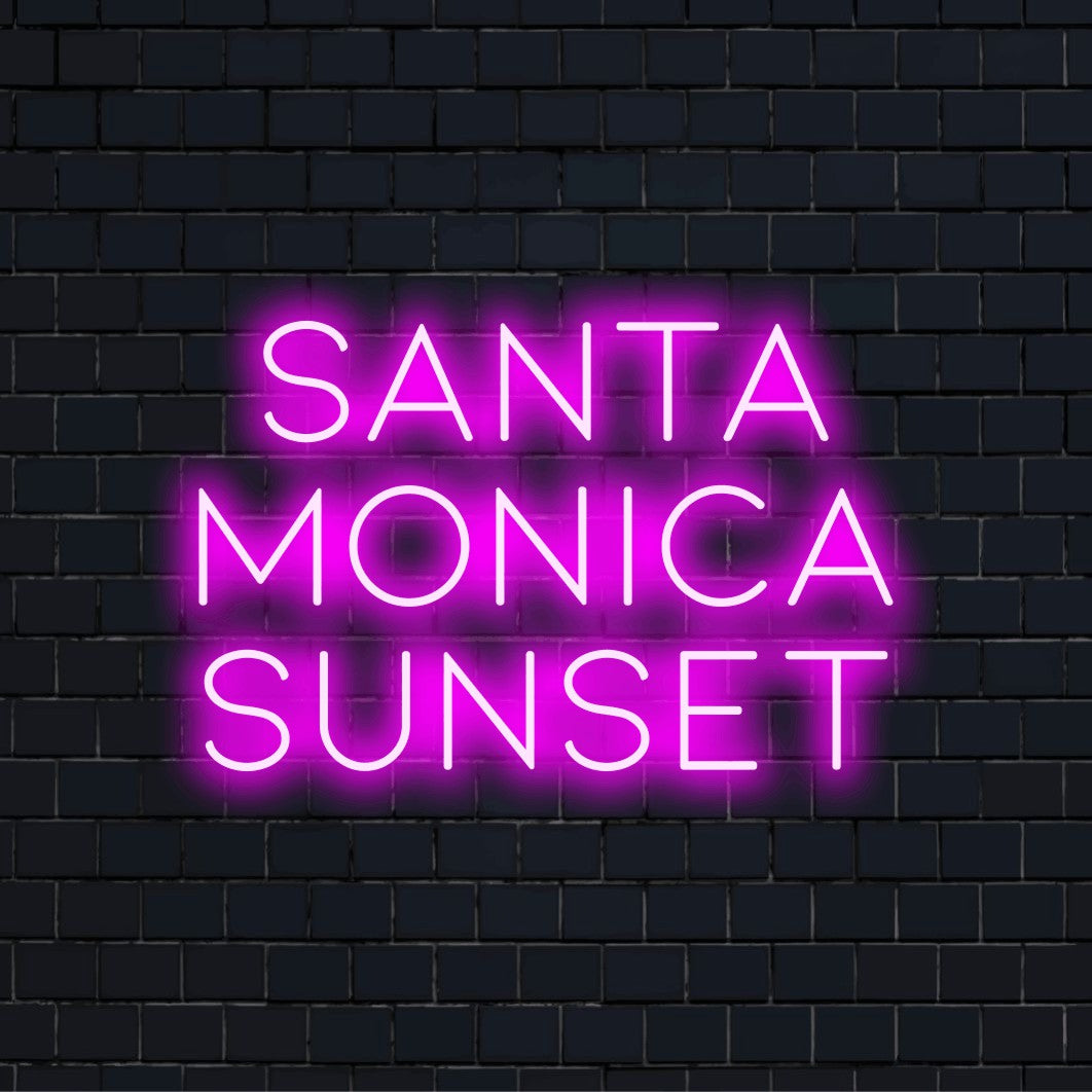 Santa Monica Sunset LED Neon Sign, glowing lettering on dark brick wall