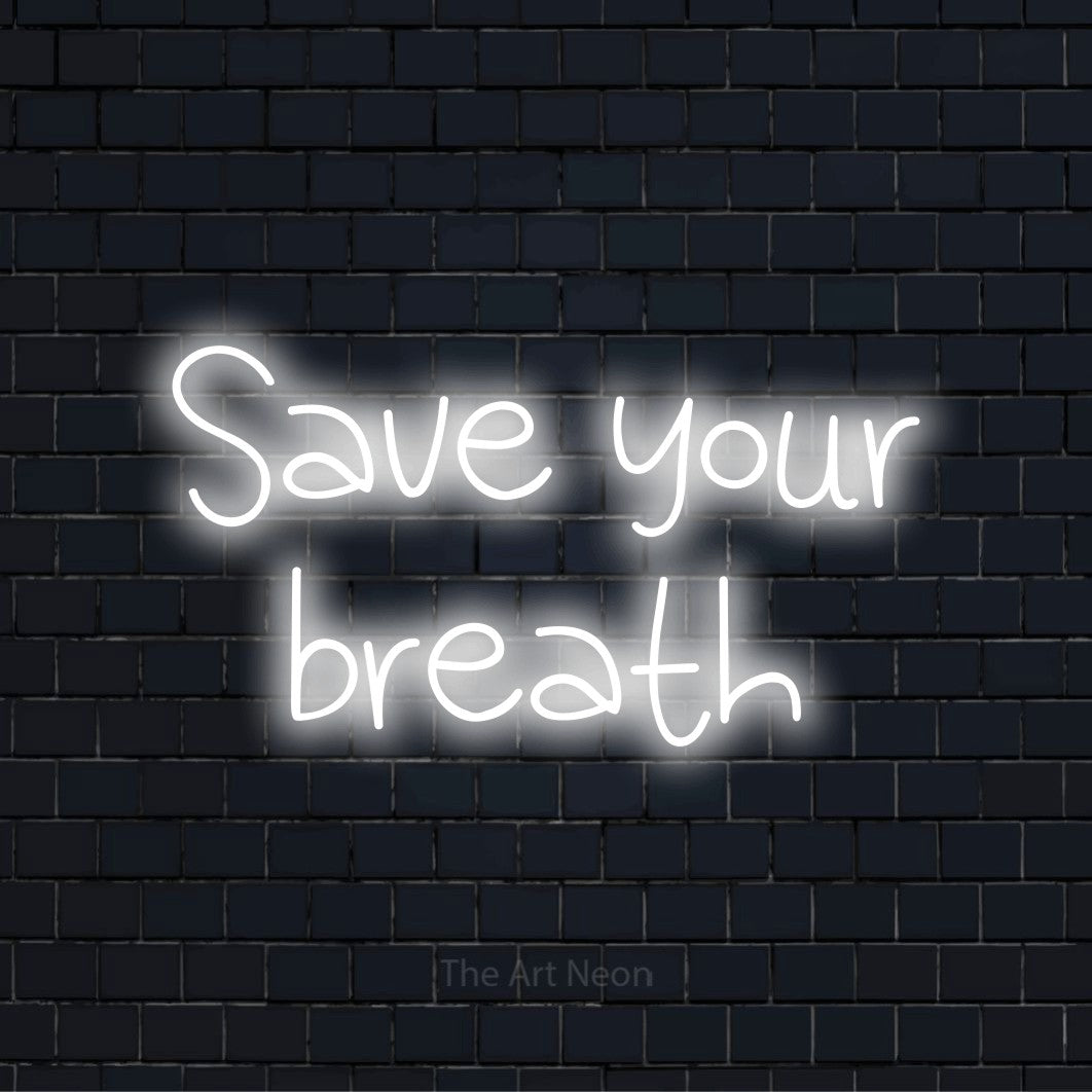"Save Your Breath" neon text design on a black brick wall