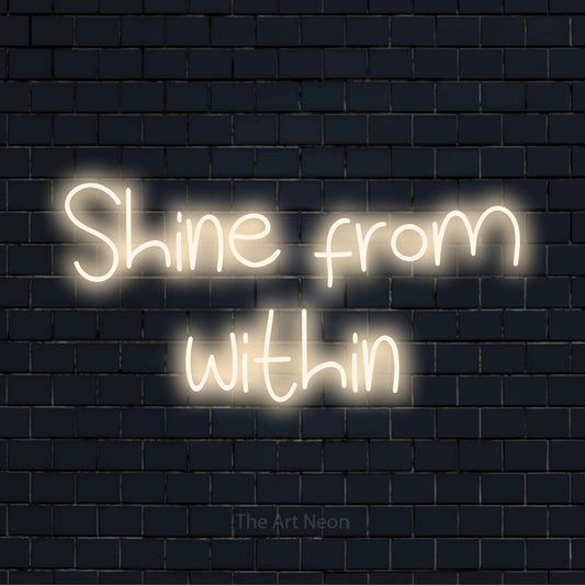 "Shine From Within" script-style LED neon sign on a black brick wall