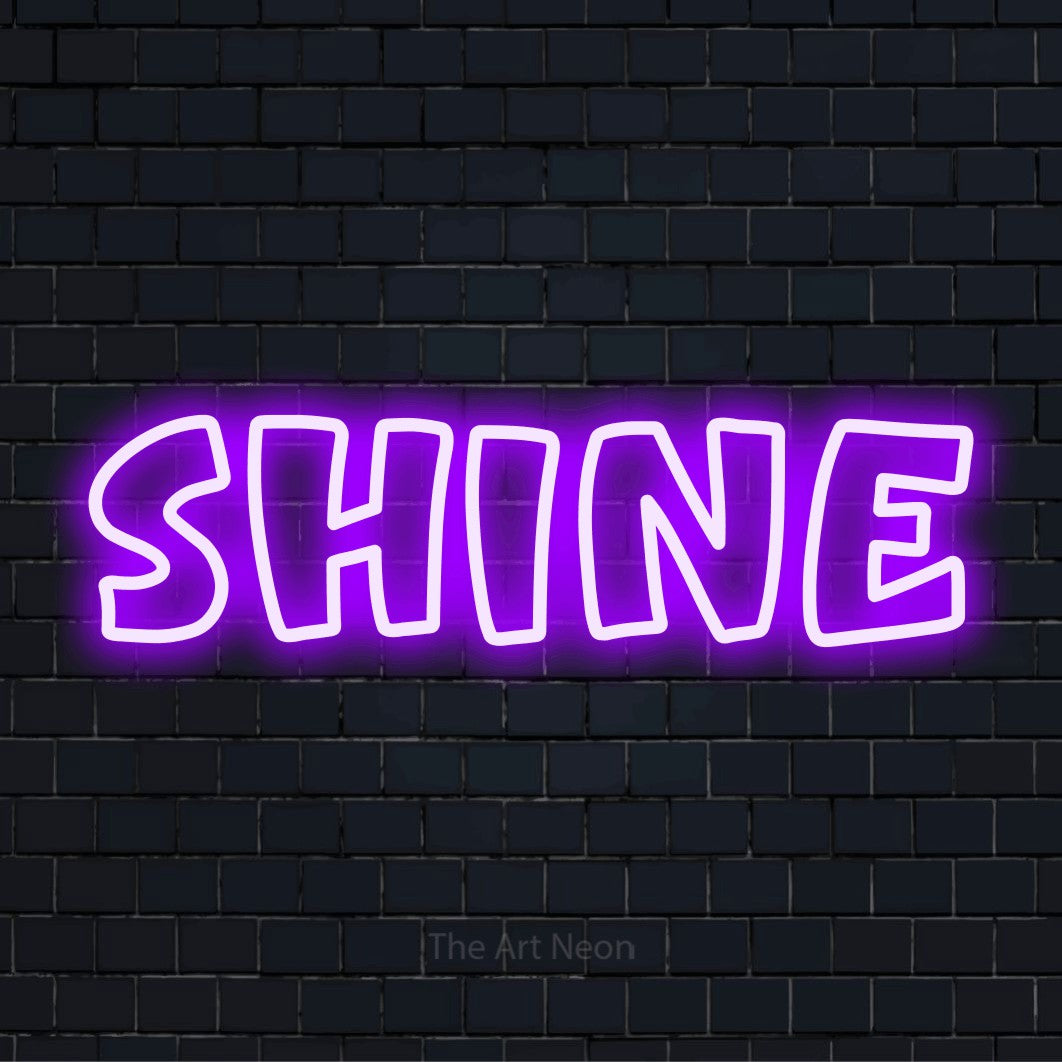"Shine" script-style LED neon sign on a black brick wall