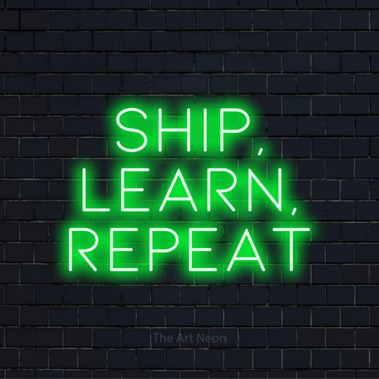 "Ship, Learn, Repeat" neon text design on a black brick wall