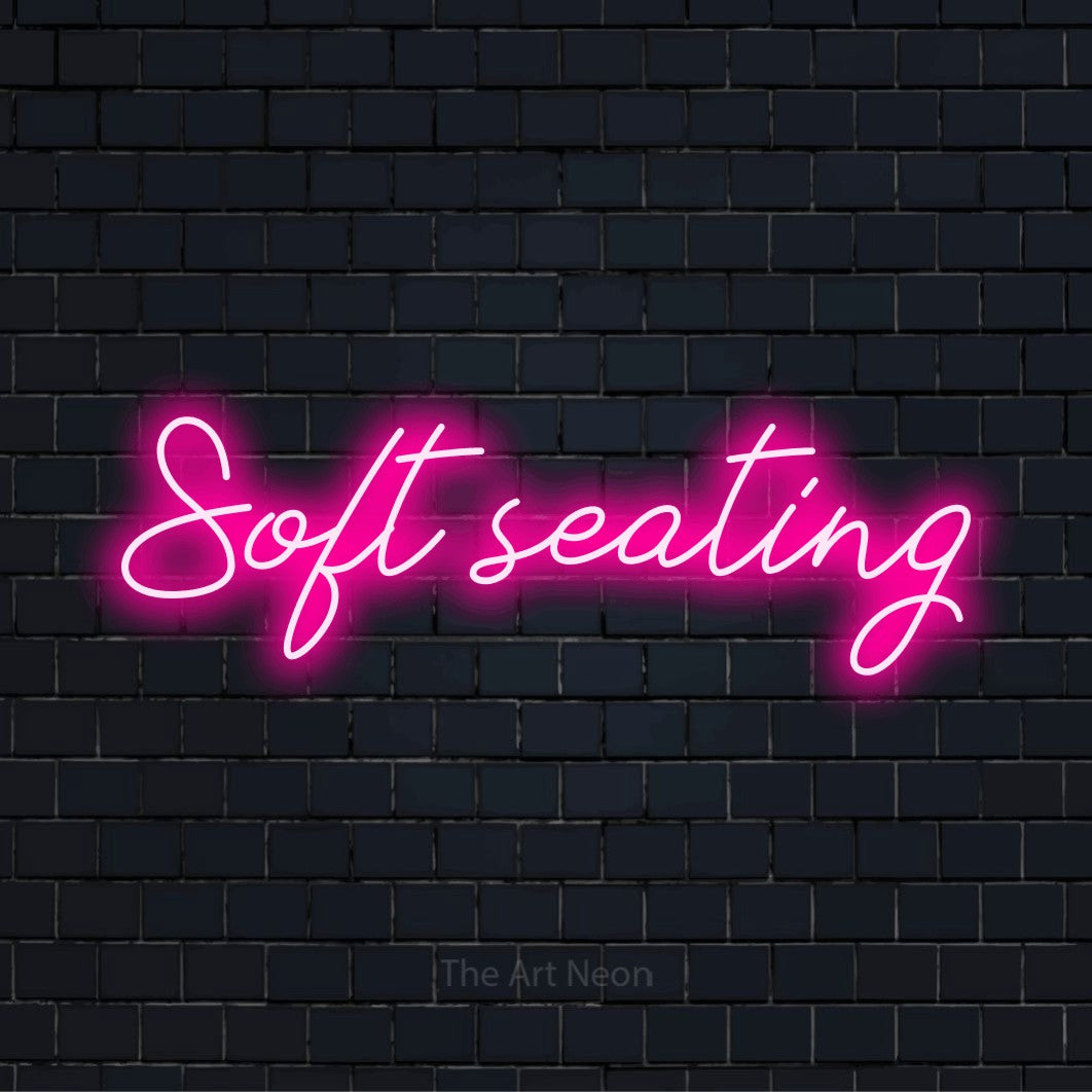 "Soft Seating" text design with neon effect on a black brick wall