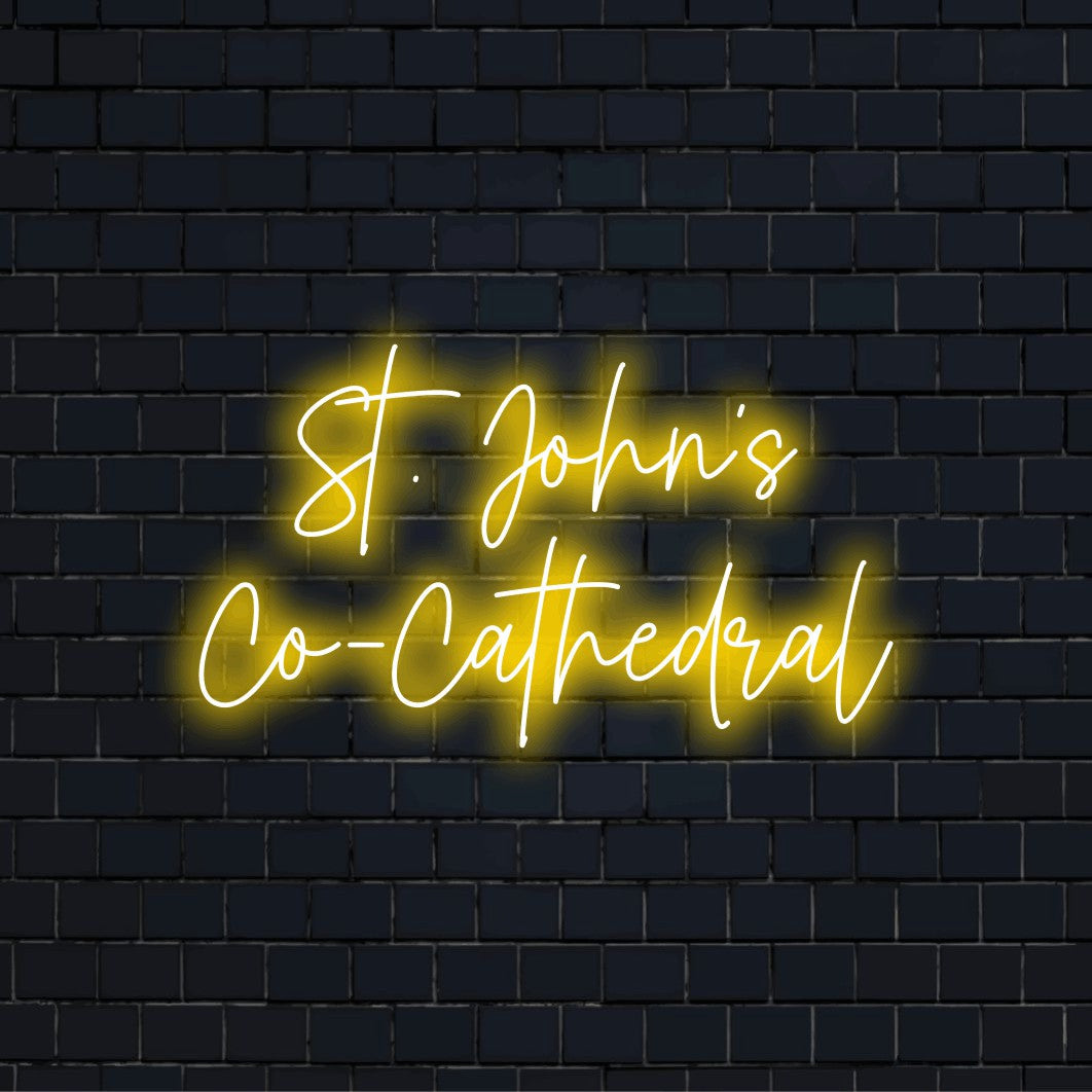 St John S Co Cathedral Neon Sign, glowing lettering on dark brick wall