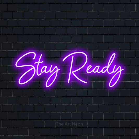 "Stay Ready" neon text design on a black brick wall