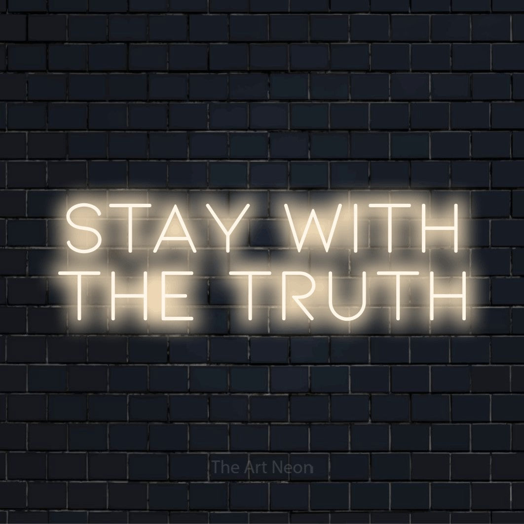 "Stay With The Truth" neon text design on a black brick wall