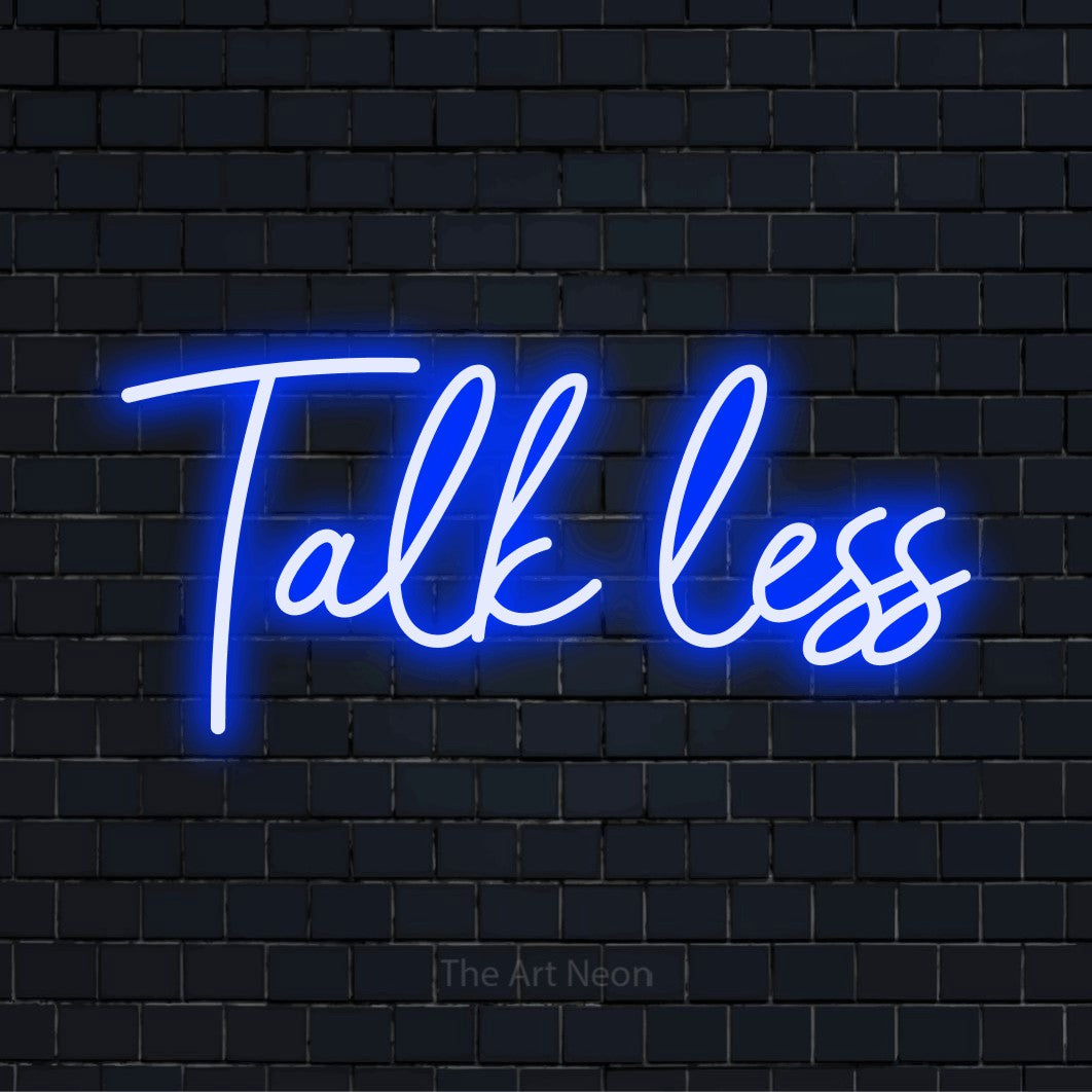 "Talk Less" glowing LED neon sign on a black brick wall