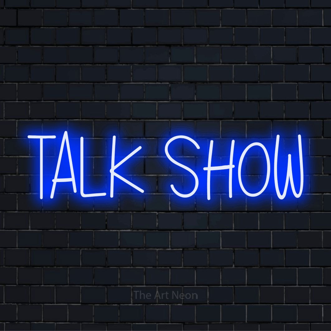"Talk Show" glowing LED neon sign on a black brick wall