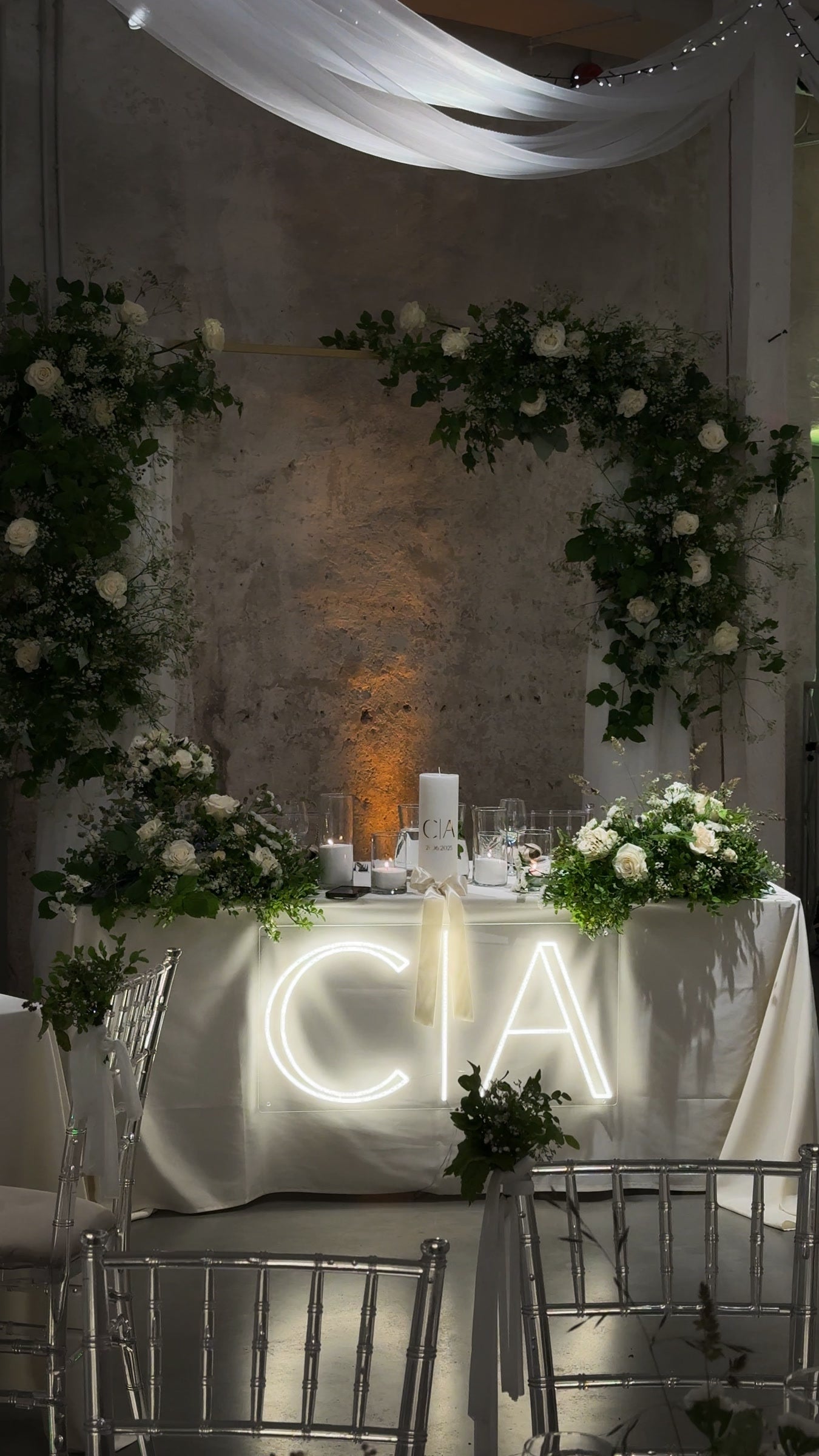 Warm-white C and A initials LED neon displayed on a table for a wedding celebration.