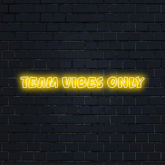 Team Vibes Only Neon Light with bright neon lettering against black brick wall